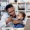 man holding a small child while talking on the phone