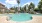 a pool with trees and buildings around it