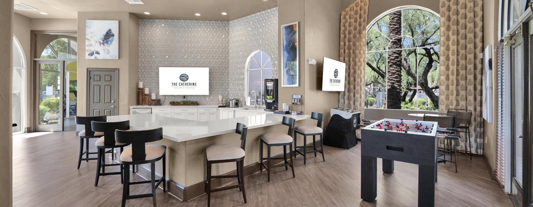 a large room with a large table tv and chairs