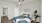 a bedroom with a bed and a fan