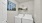 a laundry room with a picture hanging on the wall
