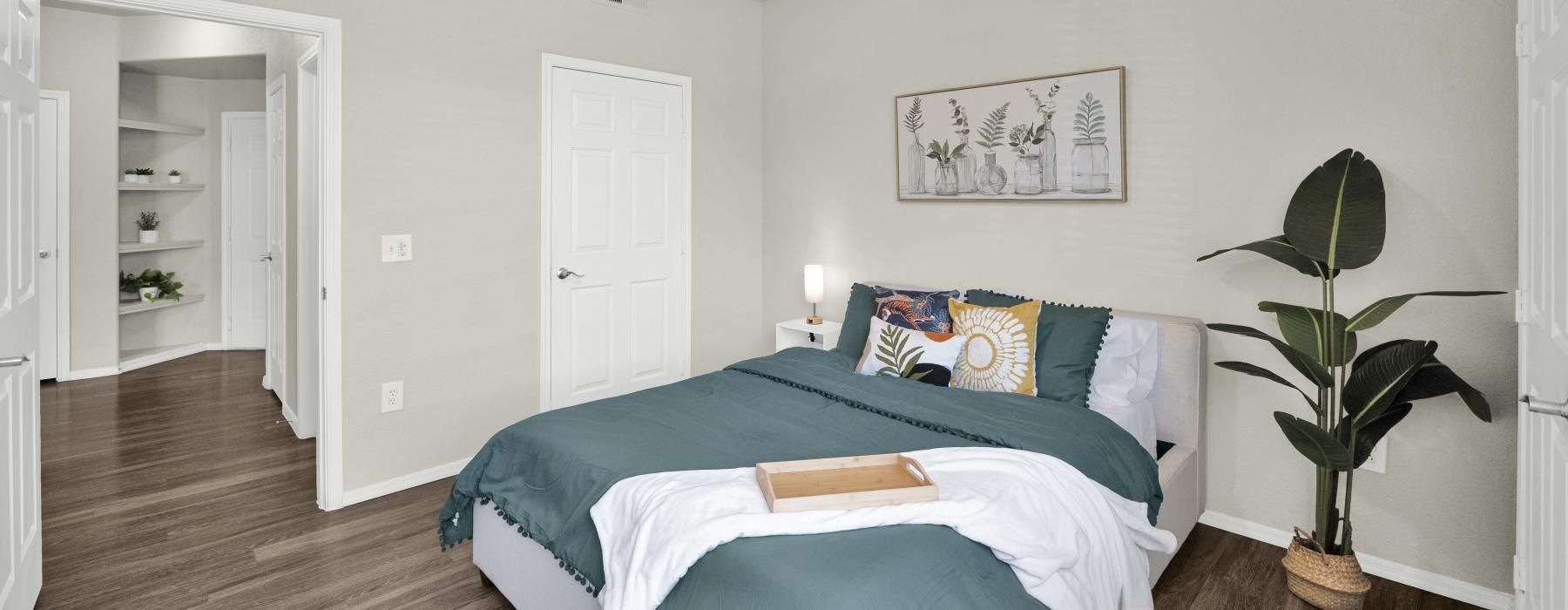 a bedroom with a bed and a fan